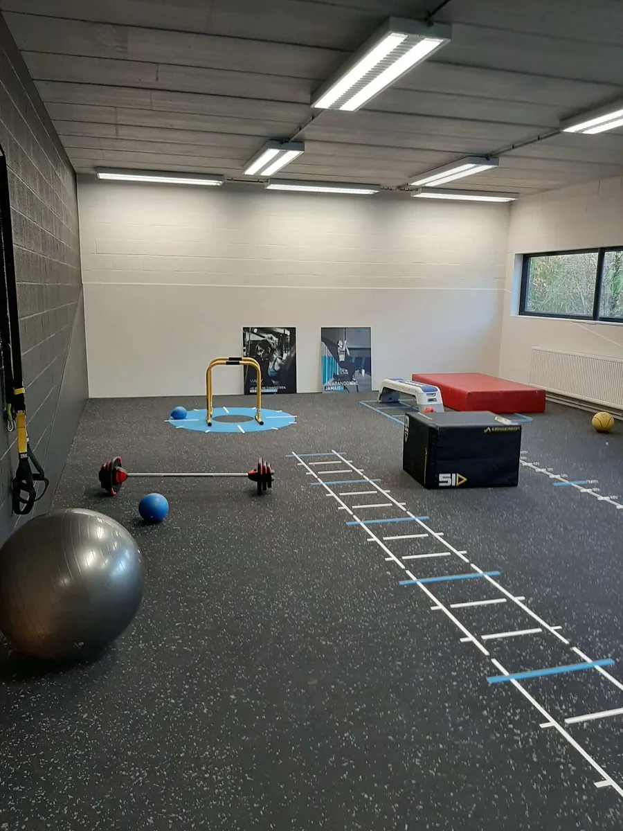 L'espace coaching, dégagé, avec ballon et échelle de rythme.